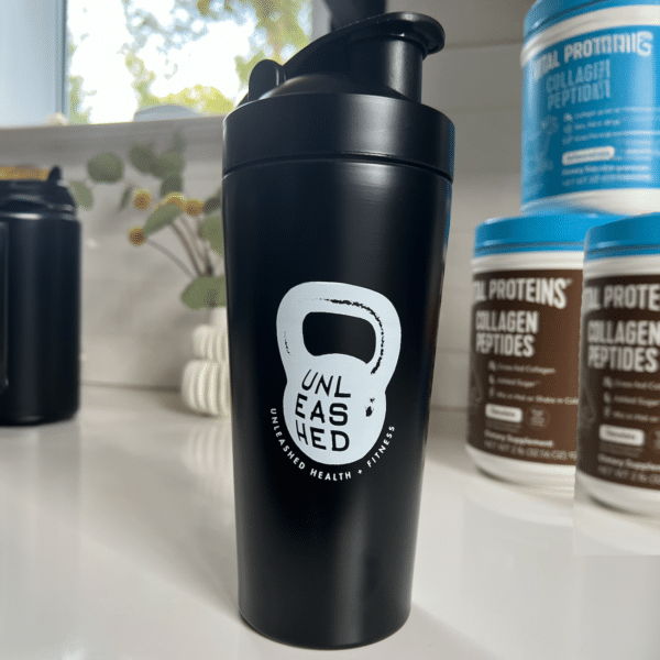 An Unleashed Health and Fitness brander protein shaker water bottle.