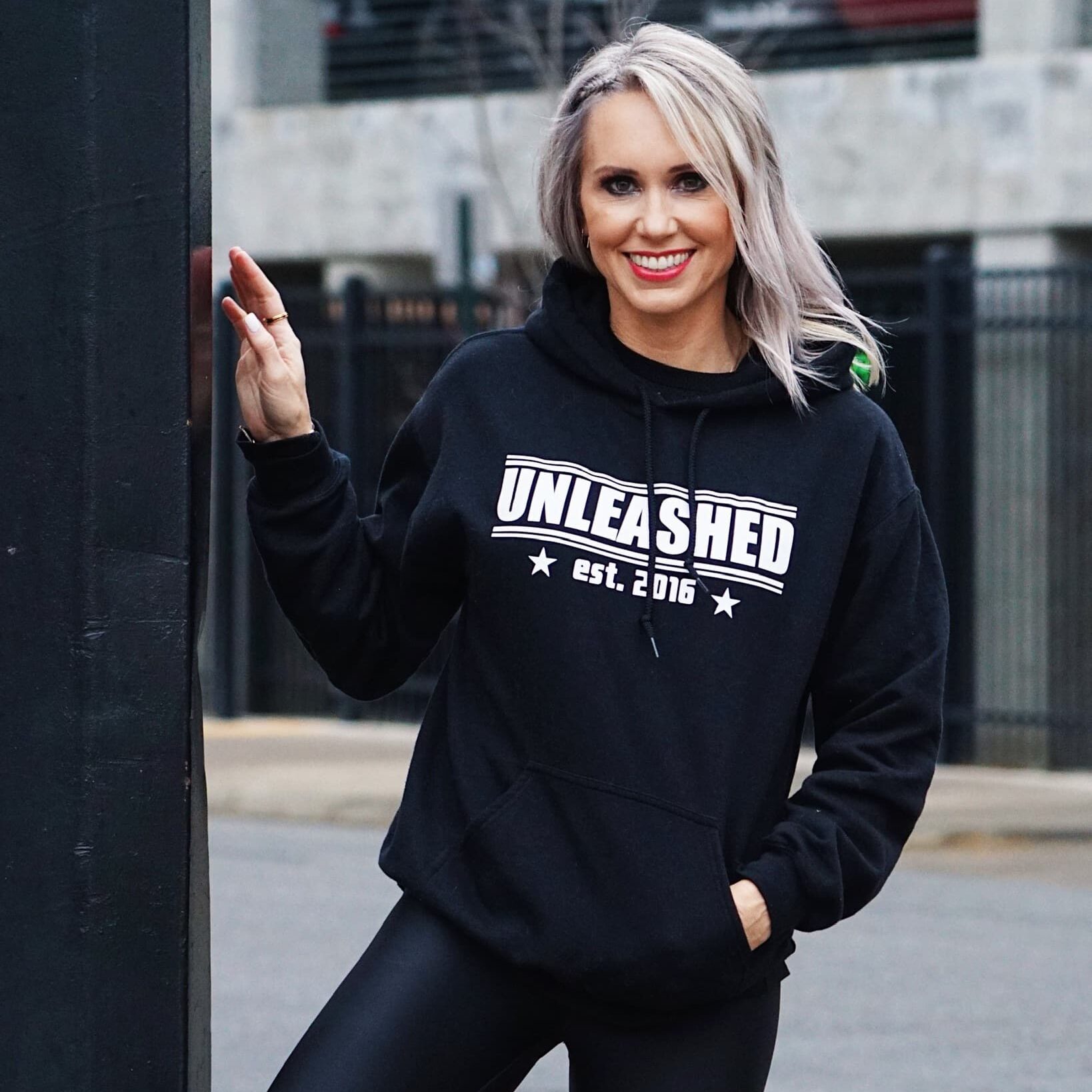 An Unleashed Health and Fitness branded black hoodie.
