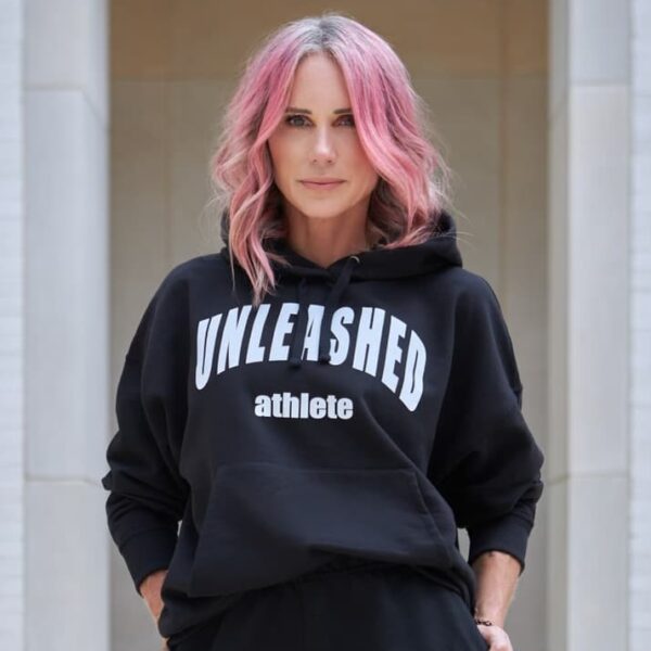 Stephanie Newcomb wearing a black hoodie with "Unleashed athlete" on the front.